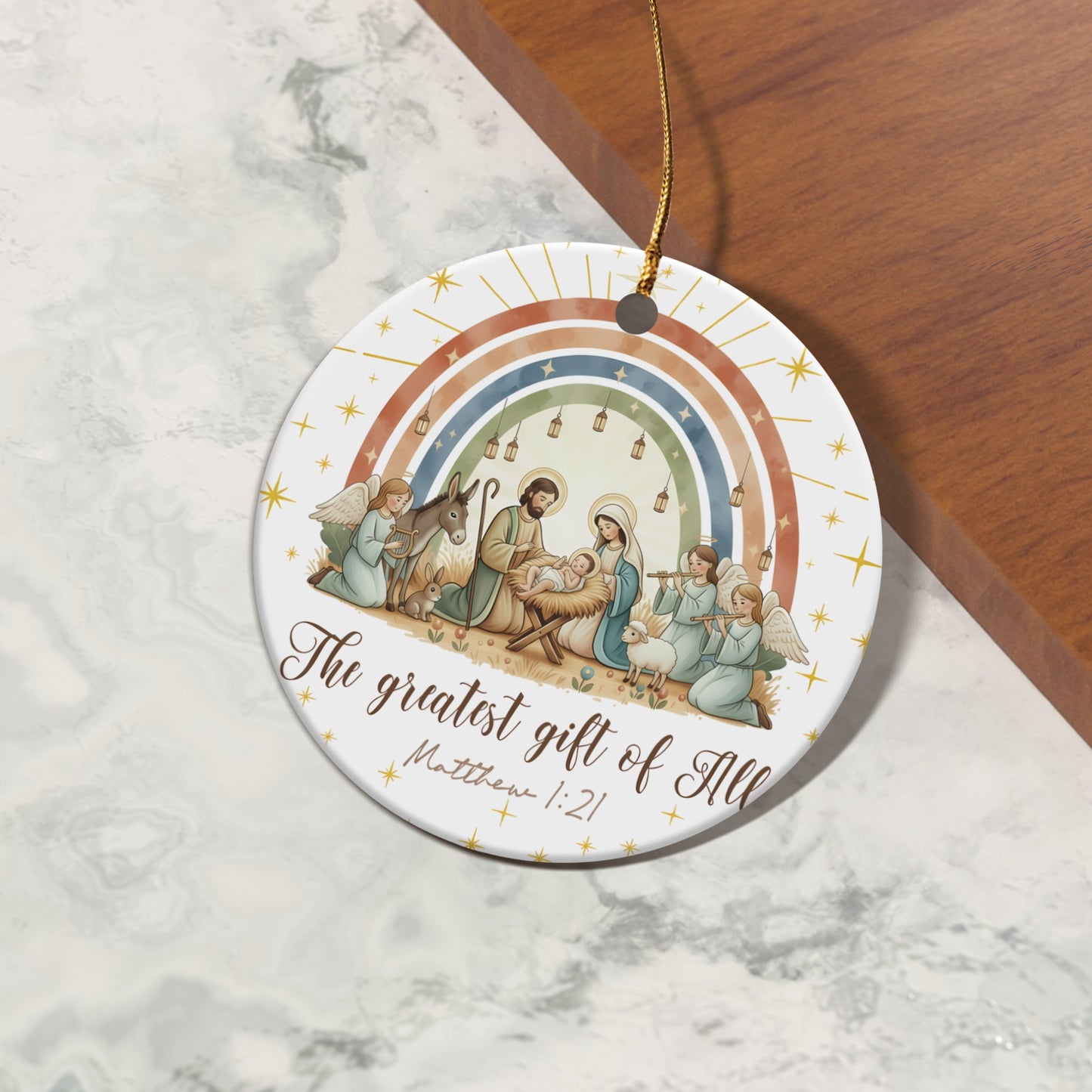 Nativity scene with angels, donkey, sheep, and rainbow, reads "The greatest gift of All Matthew 1:21".