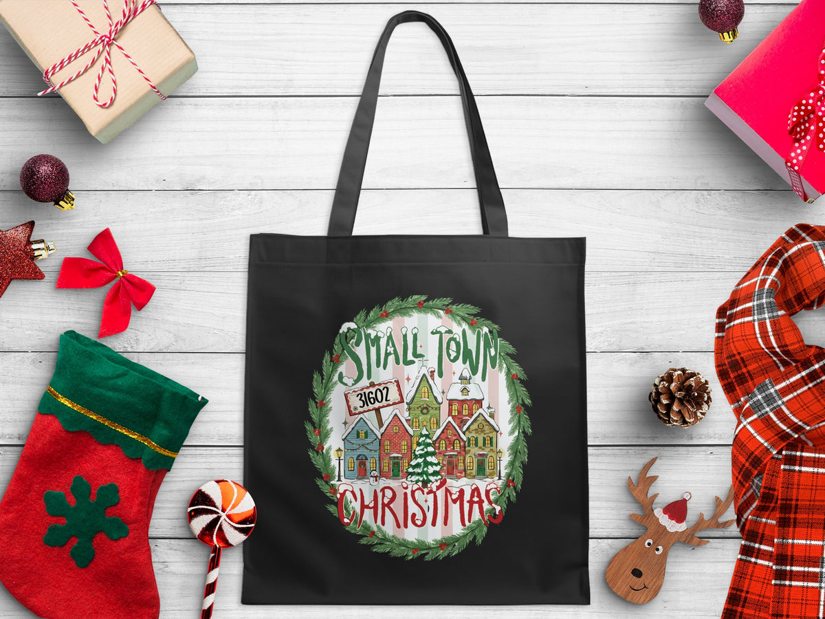 Black tote bag featuring a circular Christmas village design with "Small Town 31602 Christmas".