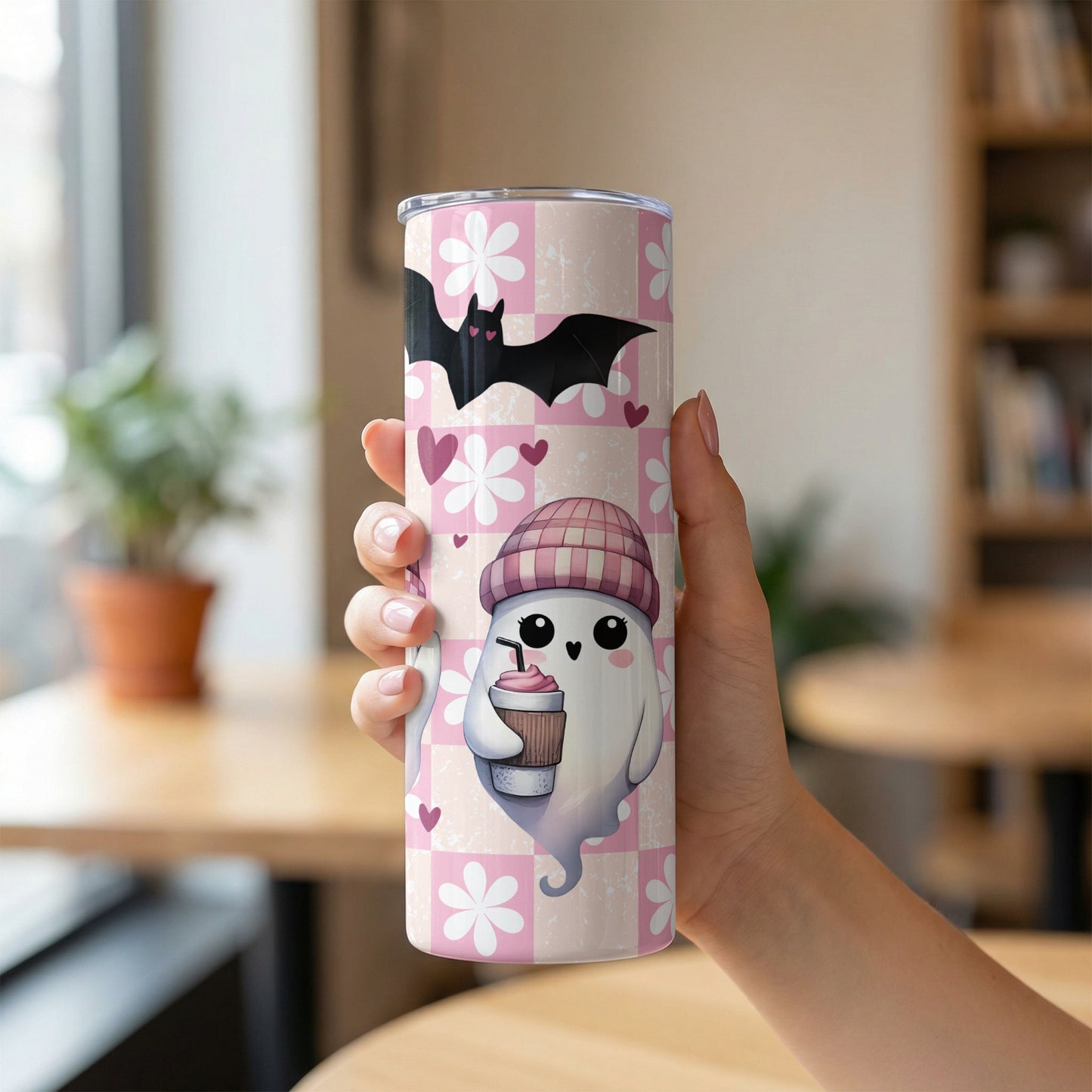 Pink checkered tumbler with ghost, bat, hearts, and flowers.