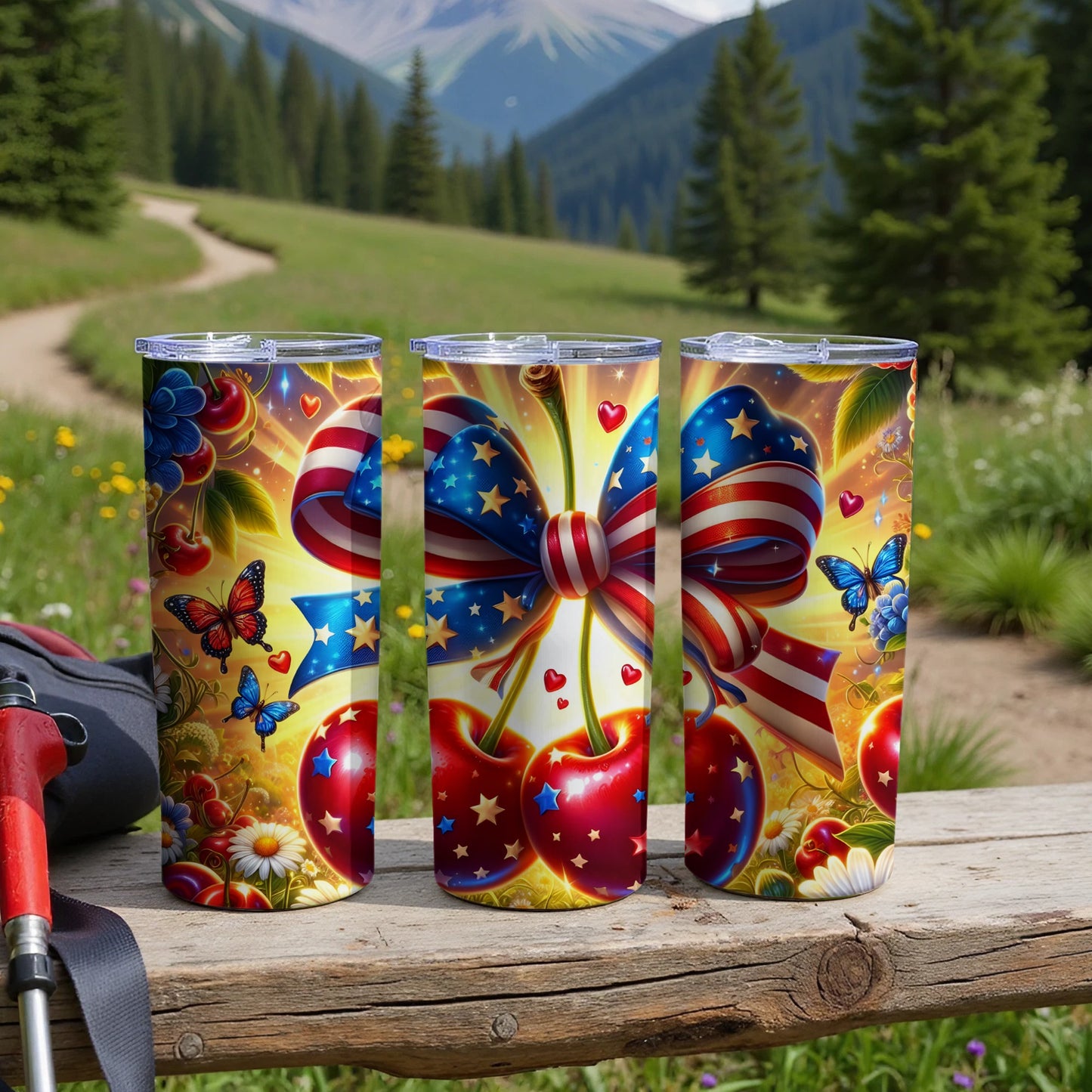 Three patriotic cherry and star decorated tumblers on a wooden surface.