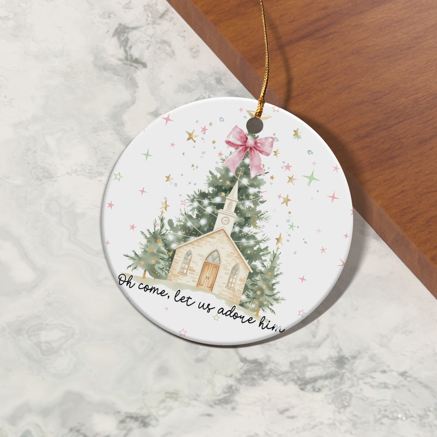 Christmas ornament with church, trees, and text "Oh come, let us adore him".