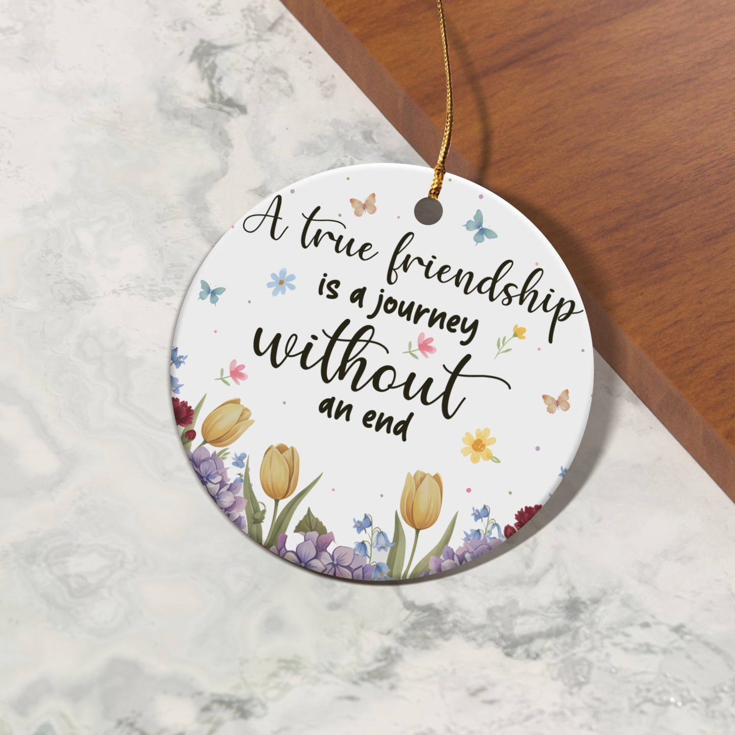 Round ornament with floral design and text "A true friendship is a journey without an end".