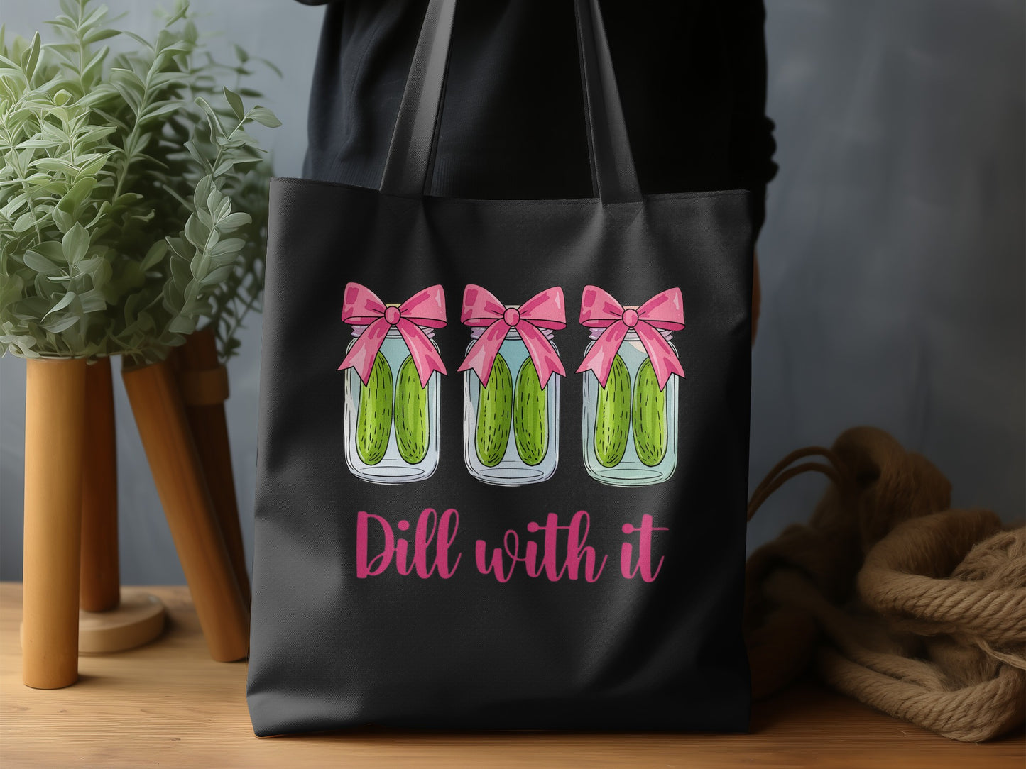 Three jars of pickles with pink bows and "Dill with it" text.