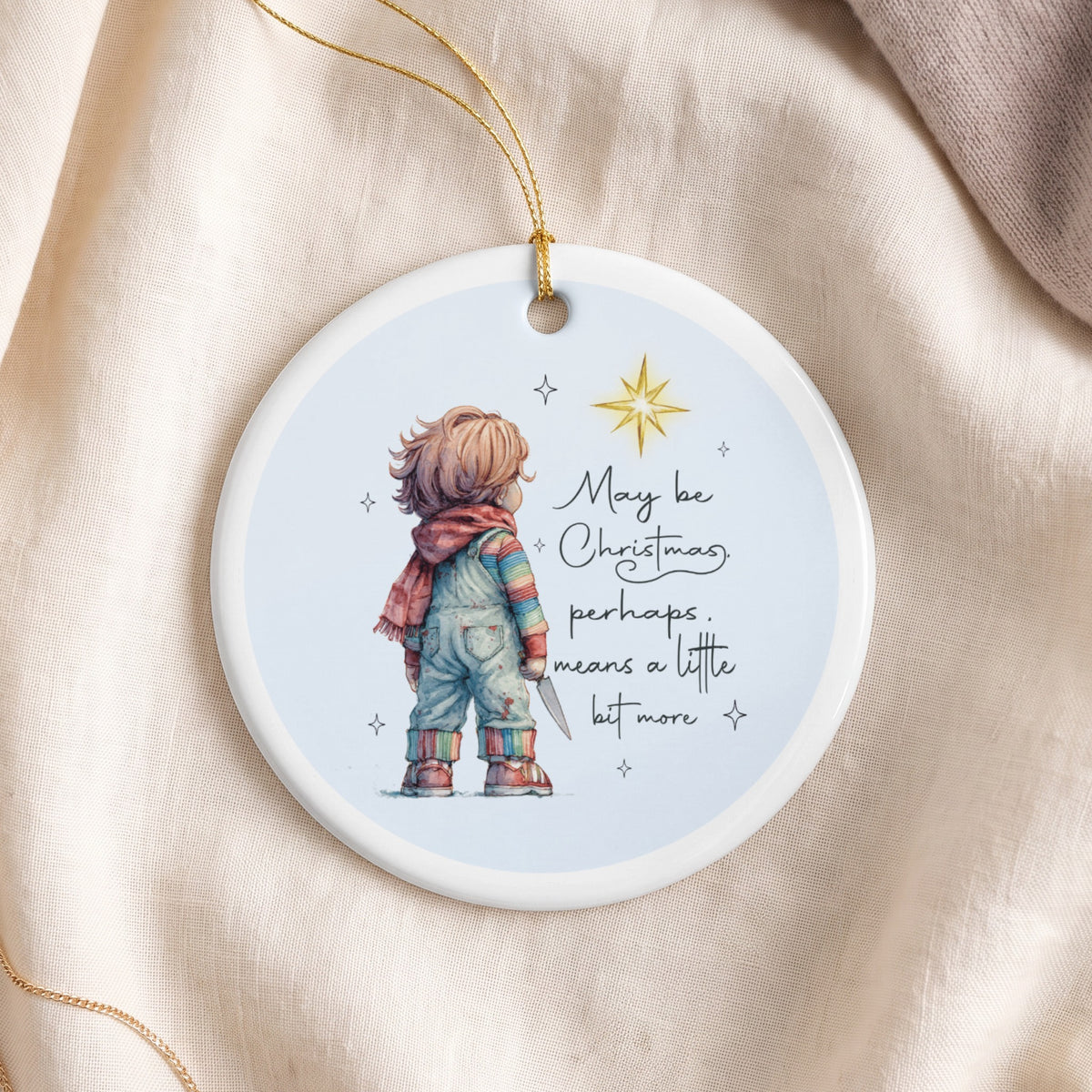 Round ornament with Chucky doll illustration and text: "May be Christmas, perhaps... means a little bit more".