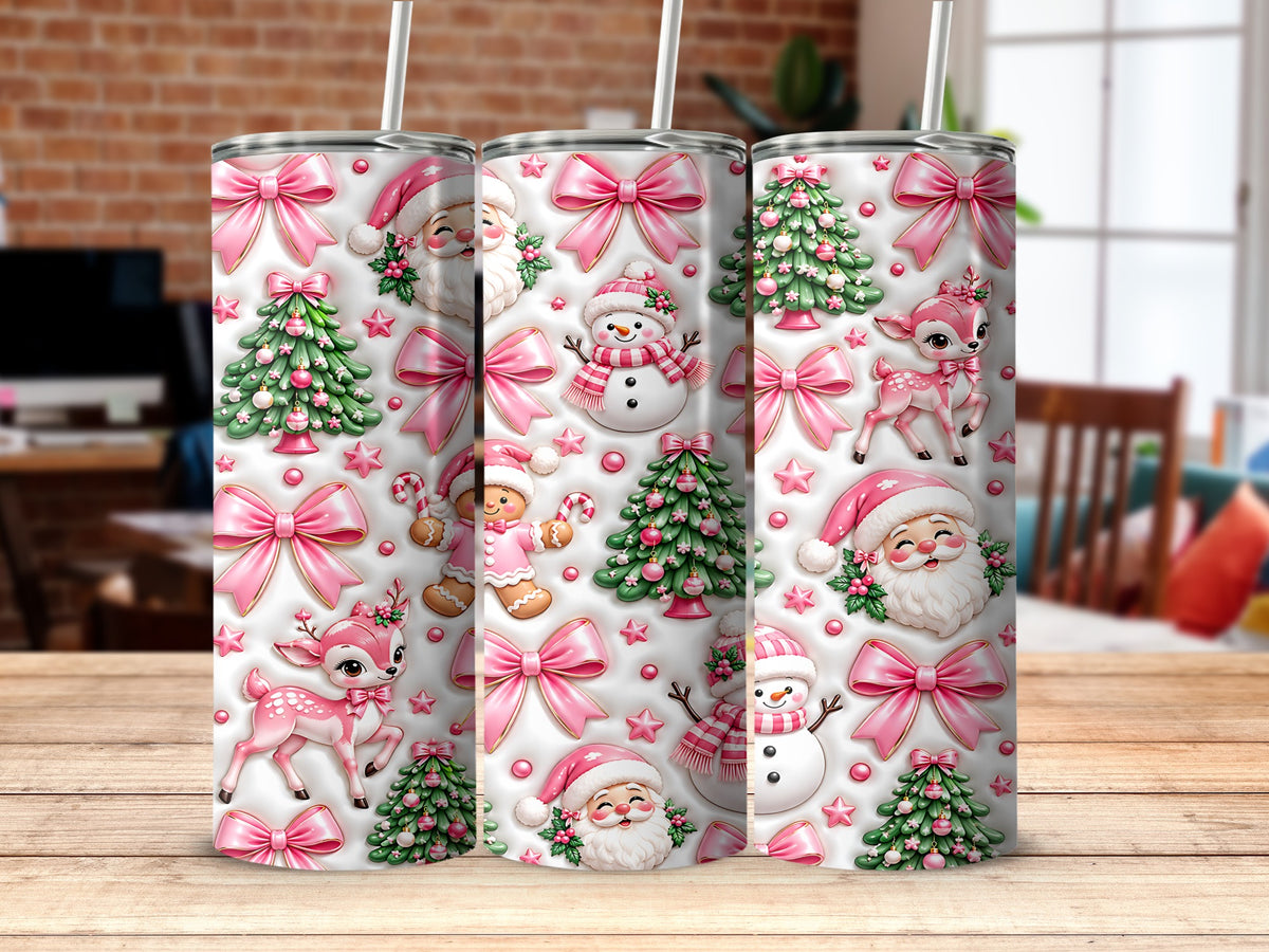 Three cylindrical tumblers stand on a wooden surface, featuring a festive pattern of pink bows, Santas, deer, and Christmas trees.