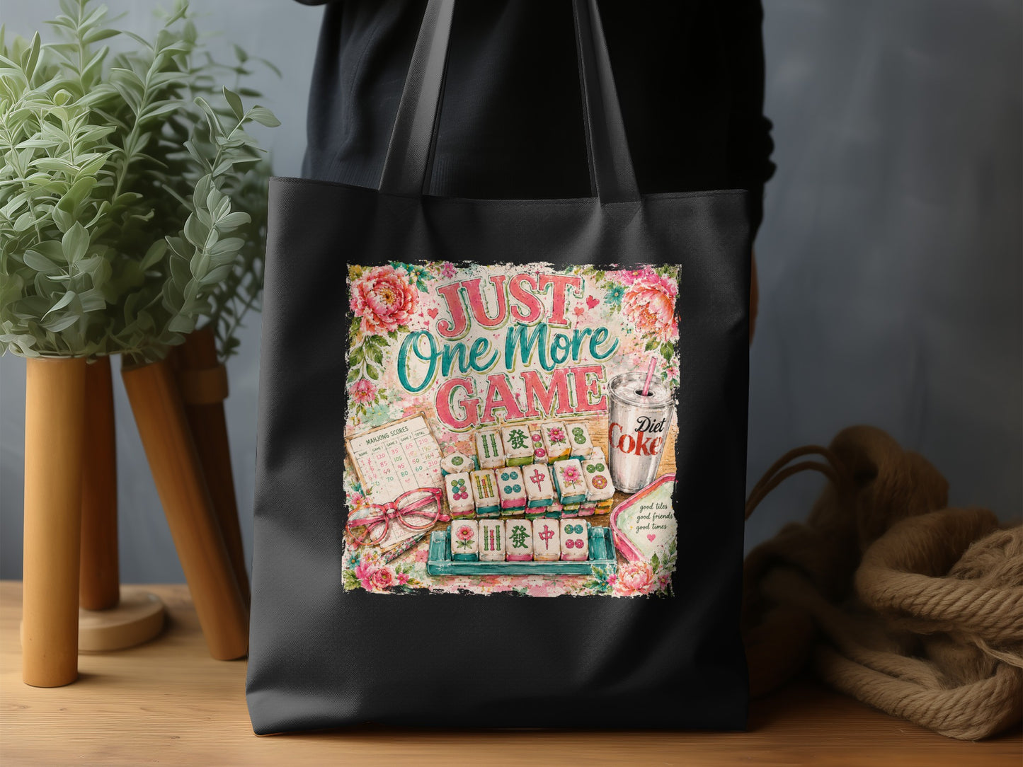 Black tote bag with "Just One More Game" and Mahjong illustration.