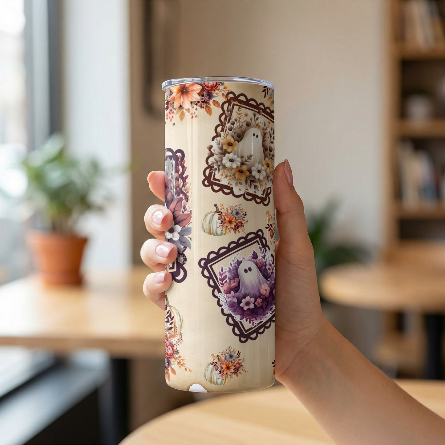 Tumbler with a cream background and a pattern of ghosts, pumpkins, and autumnal flowers.