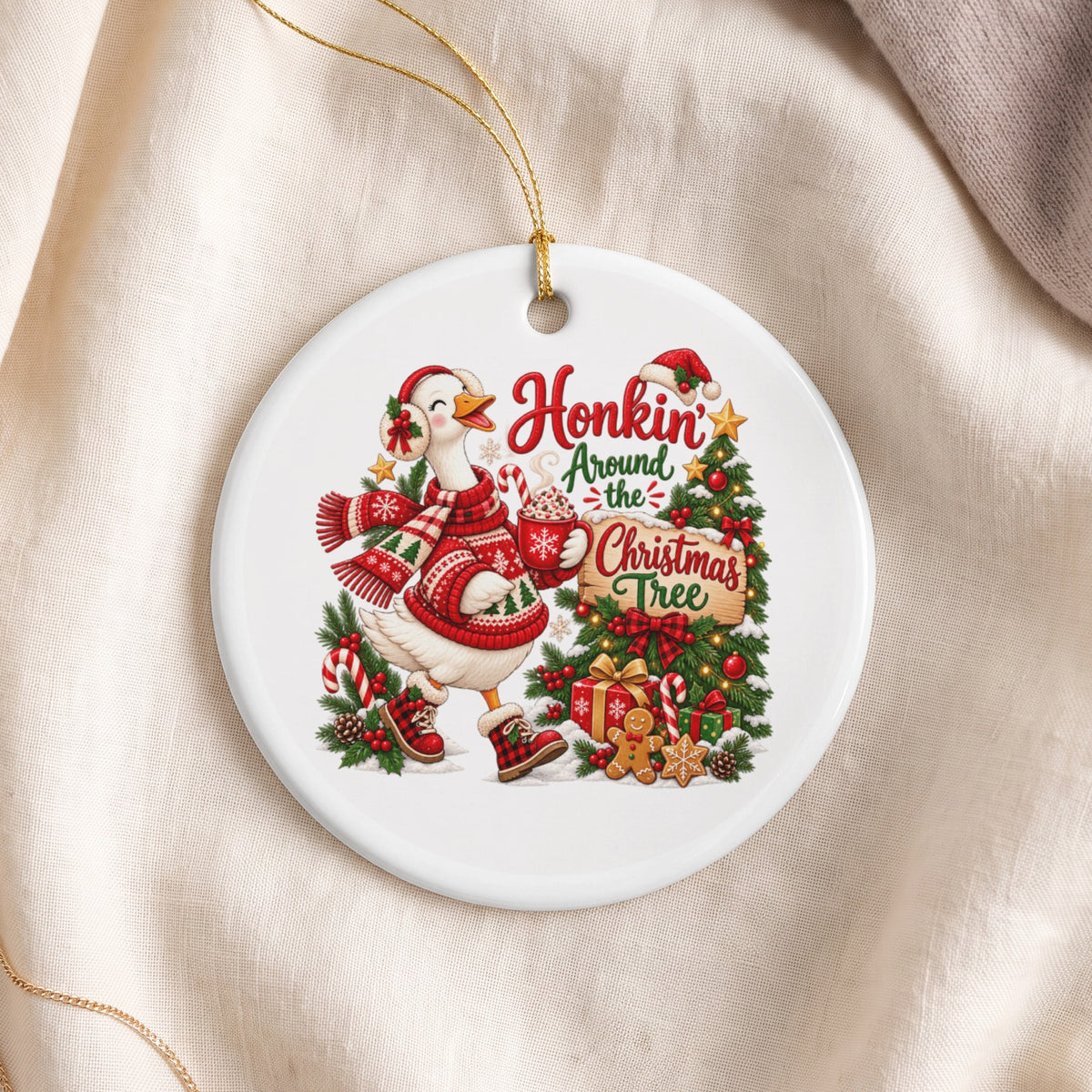 Ceramic ornament with a goose in a sweater holding hot cocoa near a Christmas tree.