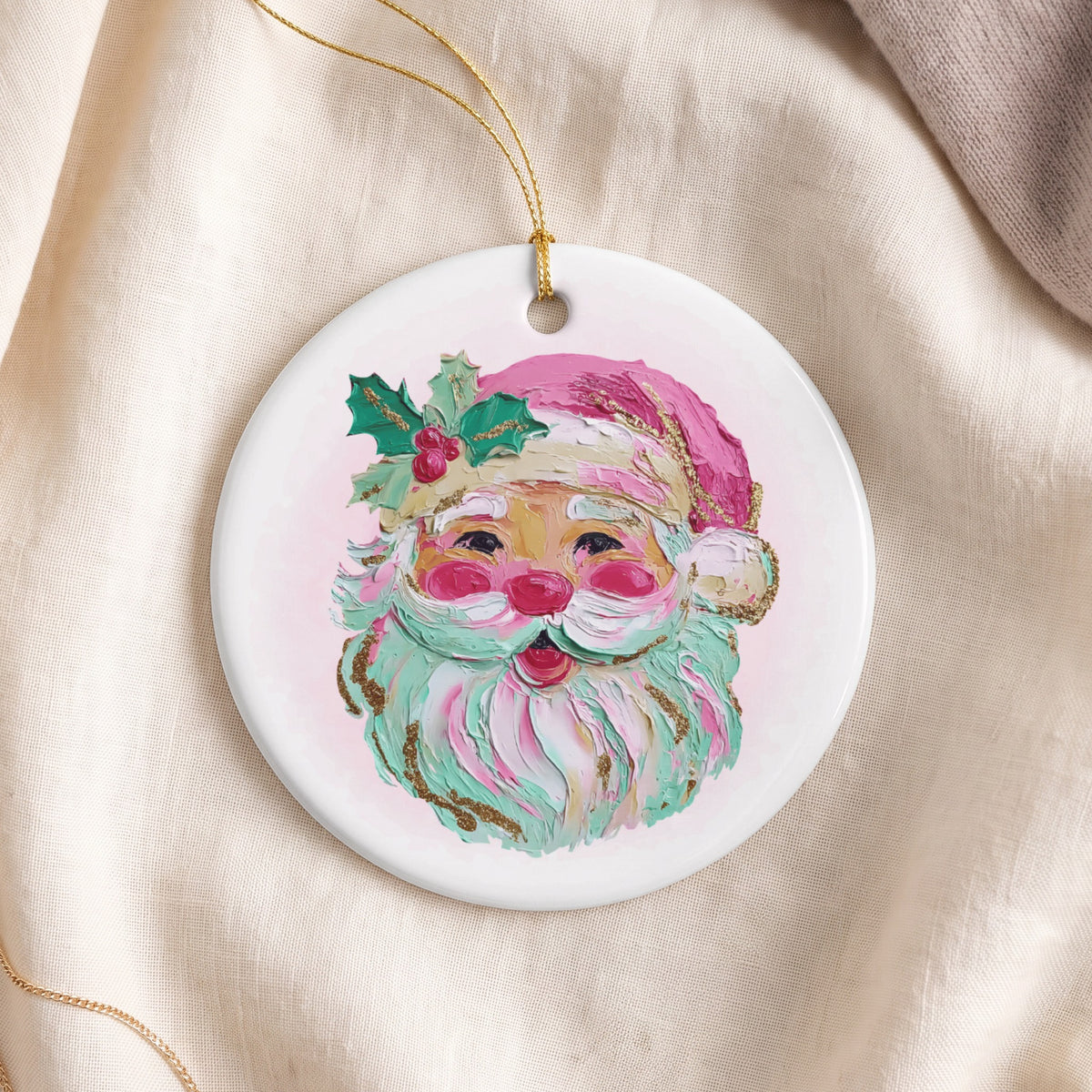 Round ornament with a painted Santa Claus face and gold hanging loop.