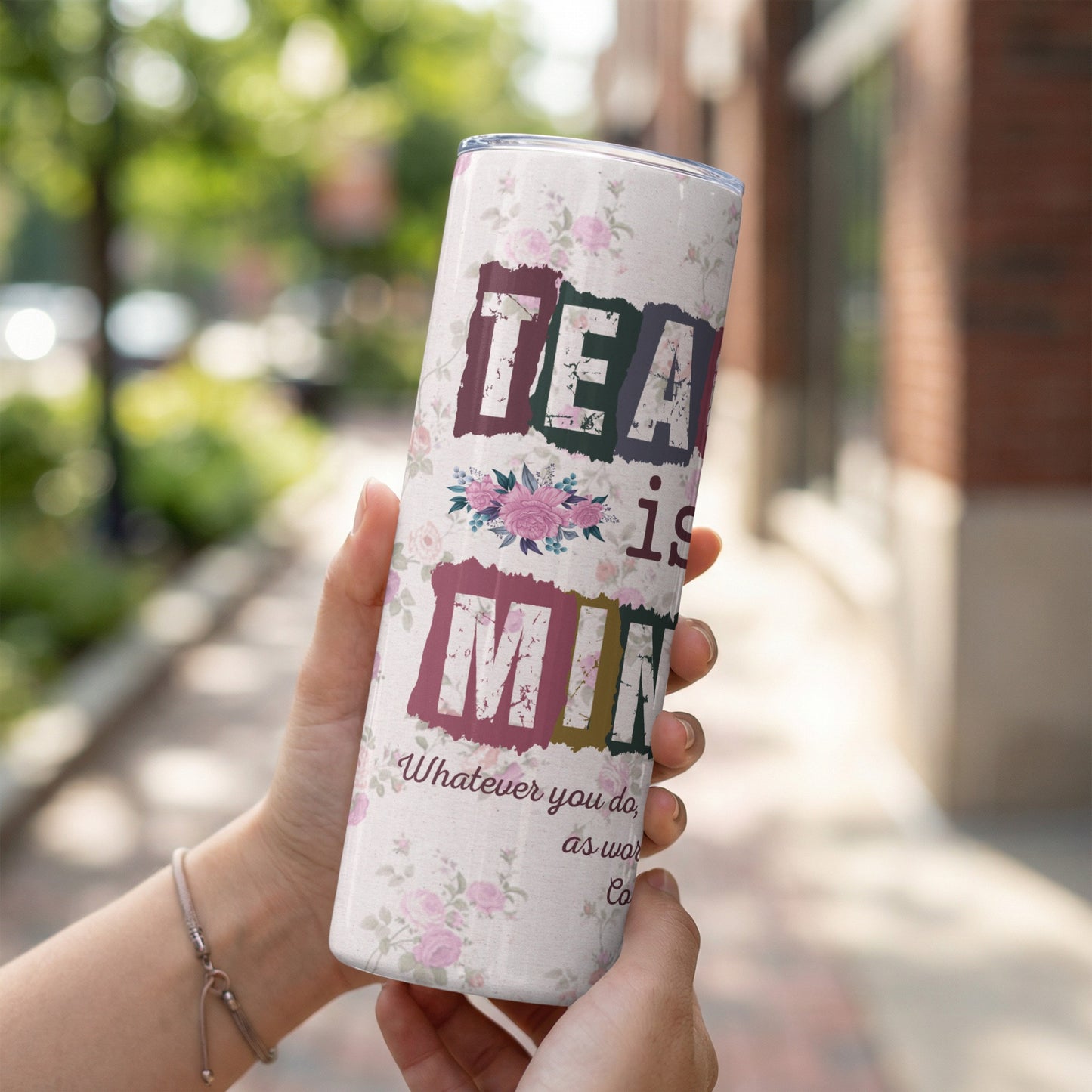 Tumbler with floral print and text "TEA is Mint. Whatever you do, as work...".