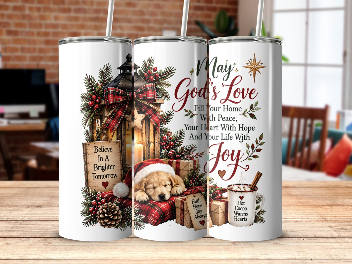 Three matching white tumblers displayed side-by-side on a wooden table, featuring Christmas graphics including a sleeping puppy, lantern, and text.