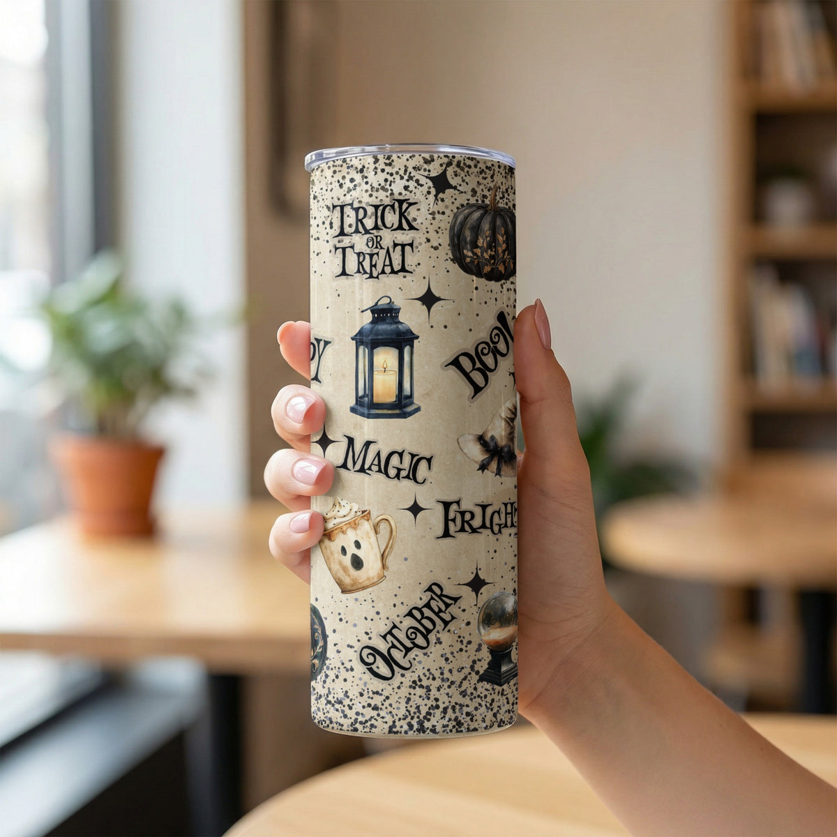 Tumbler with Halloween-themed graphics including "Trick or Treat" and spooky objects.
