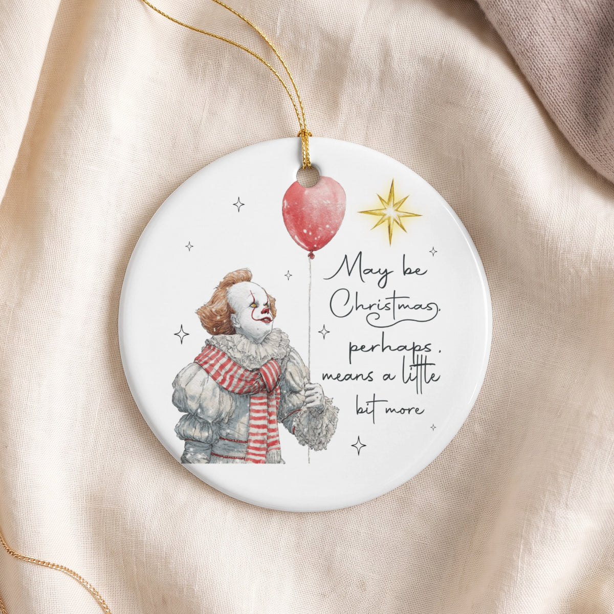 Round ornament featuring Pennywise the clown holding a balloon with Christmas text.