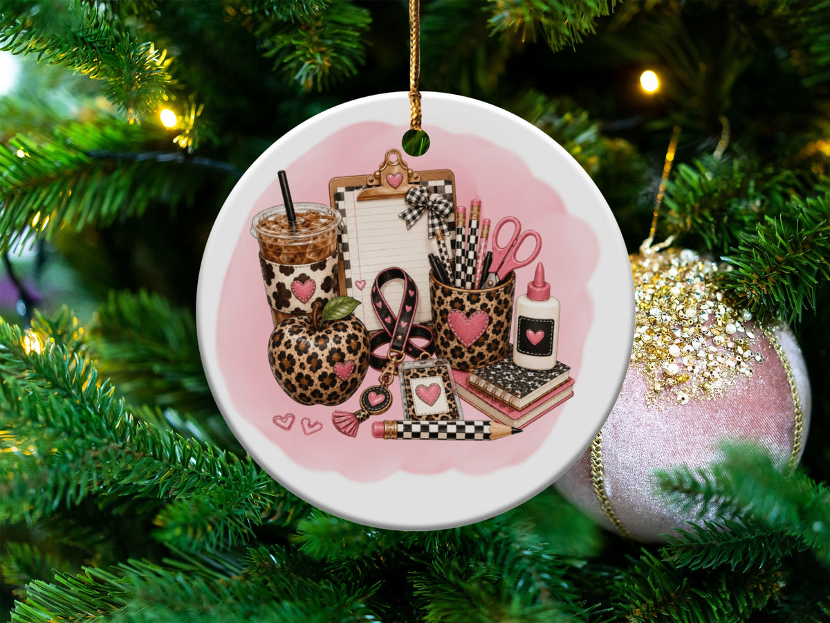 Round ornament with leopard print teacher items and pink accents on a Christmas tree.