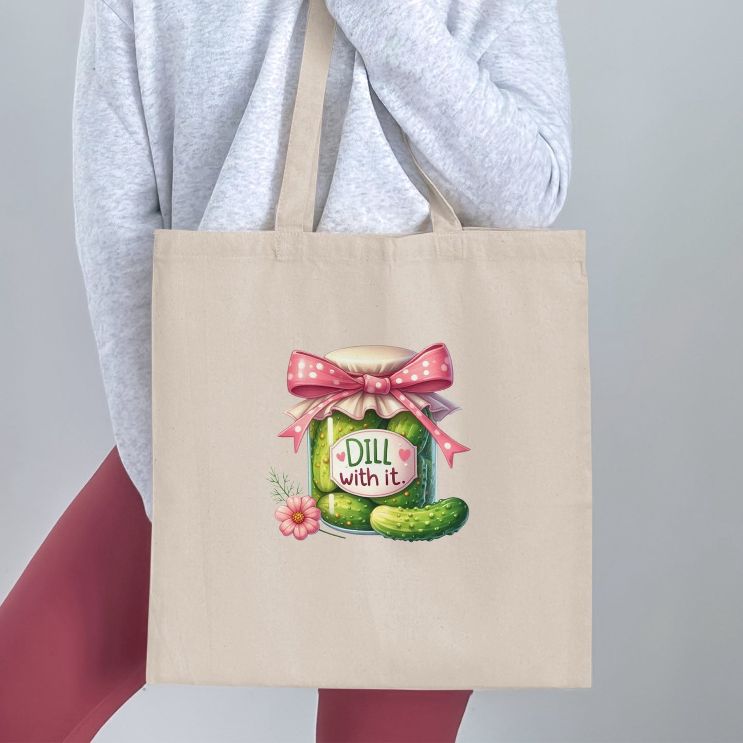 Tote bag with a cartoon dill pickle jar with a pink bow.
