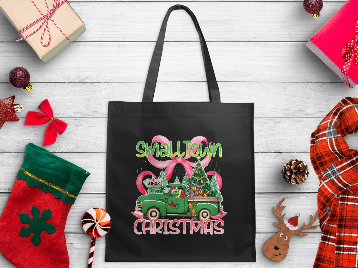 Black tote bag with "SmallTown Christmas" design featuring a green truck and trees.