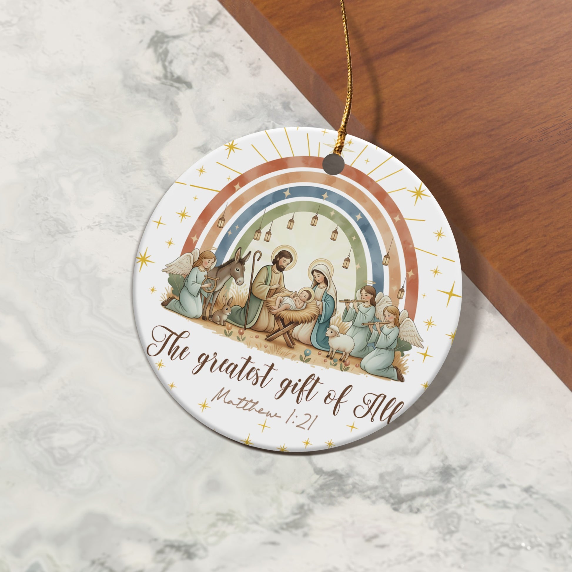 Nativity scene with angels, donkey, sheep, and rainbow, reads "The greatest gift of All Matthew 1:21".