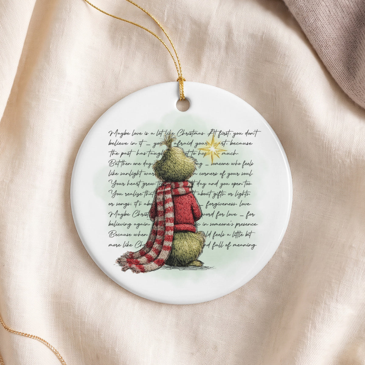 Grinch ornament with inspirational text about love and Christmas.