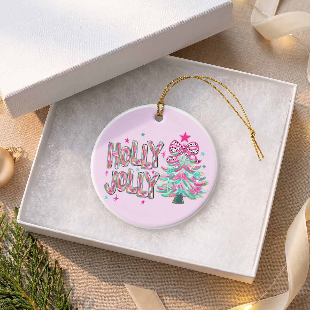 Round ornament with "HOLLY JOLLY" text and a Christmas tree in an open gift box.