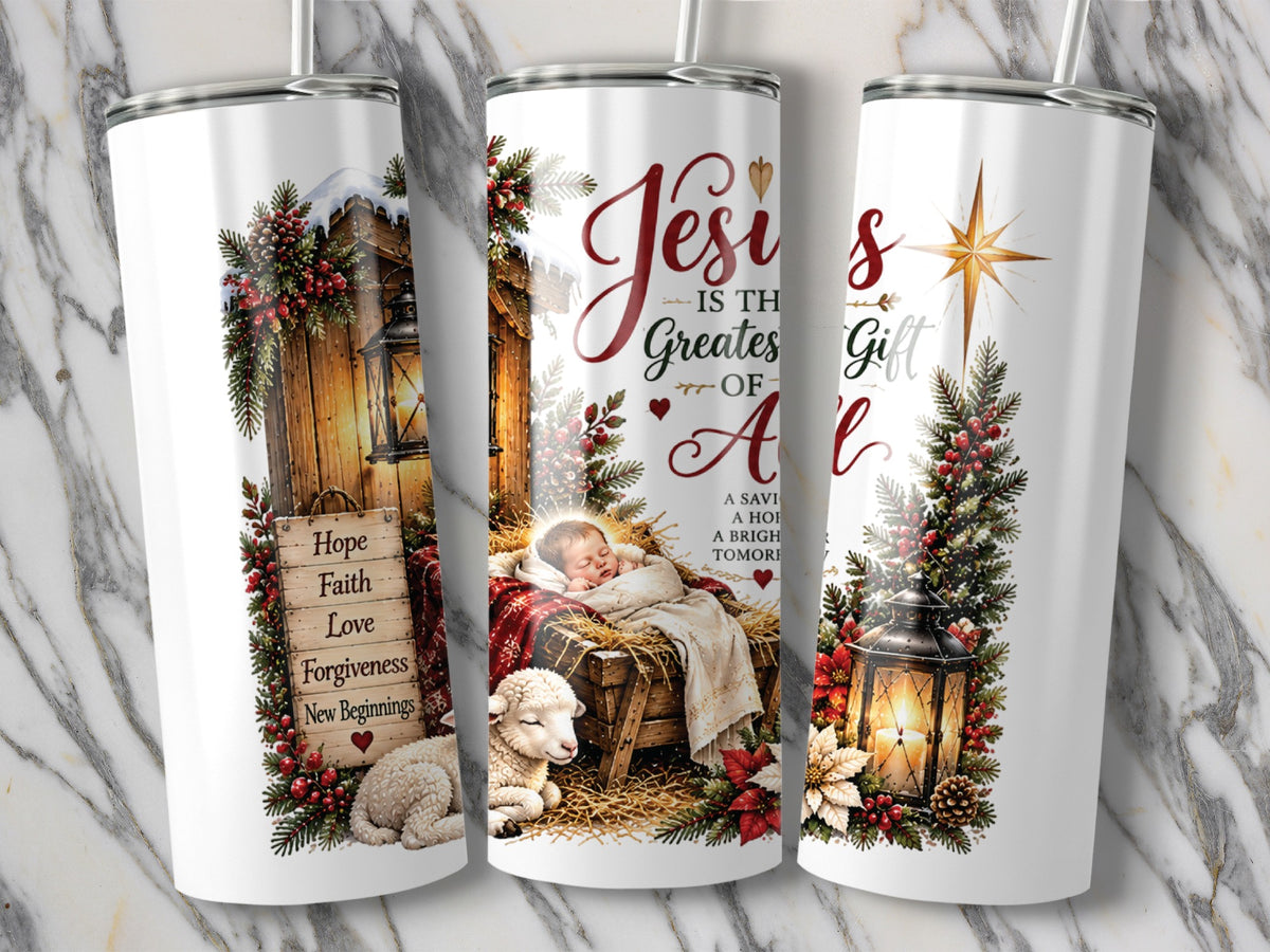 Three white tumblers display a nativity scene with baby Jesus, a lamb, and Christmas holiday greenery.