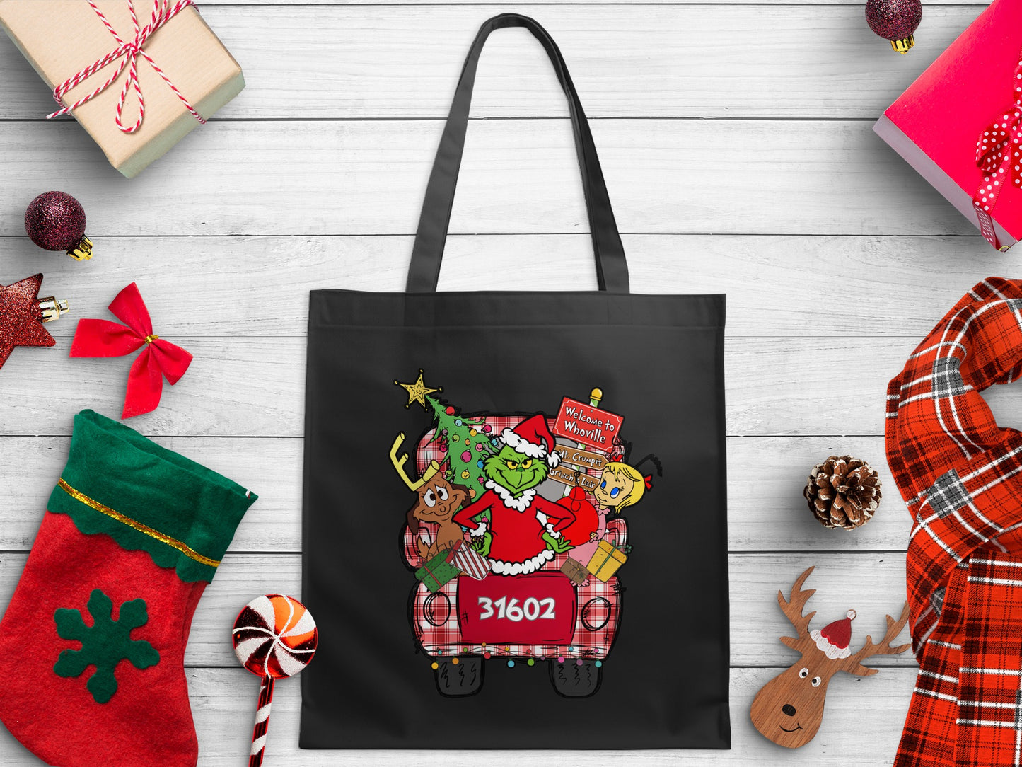 Black tote bag with Grinch characters and Christmas tree in a truck with "31602"