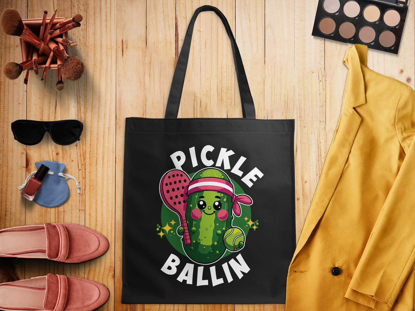 Tote bag with cartoon pickle holding paddle and ball, "Pickle Ballin'" text.