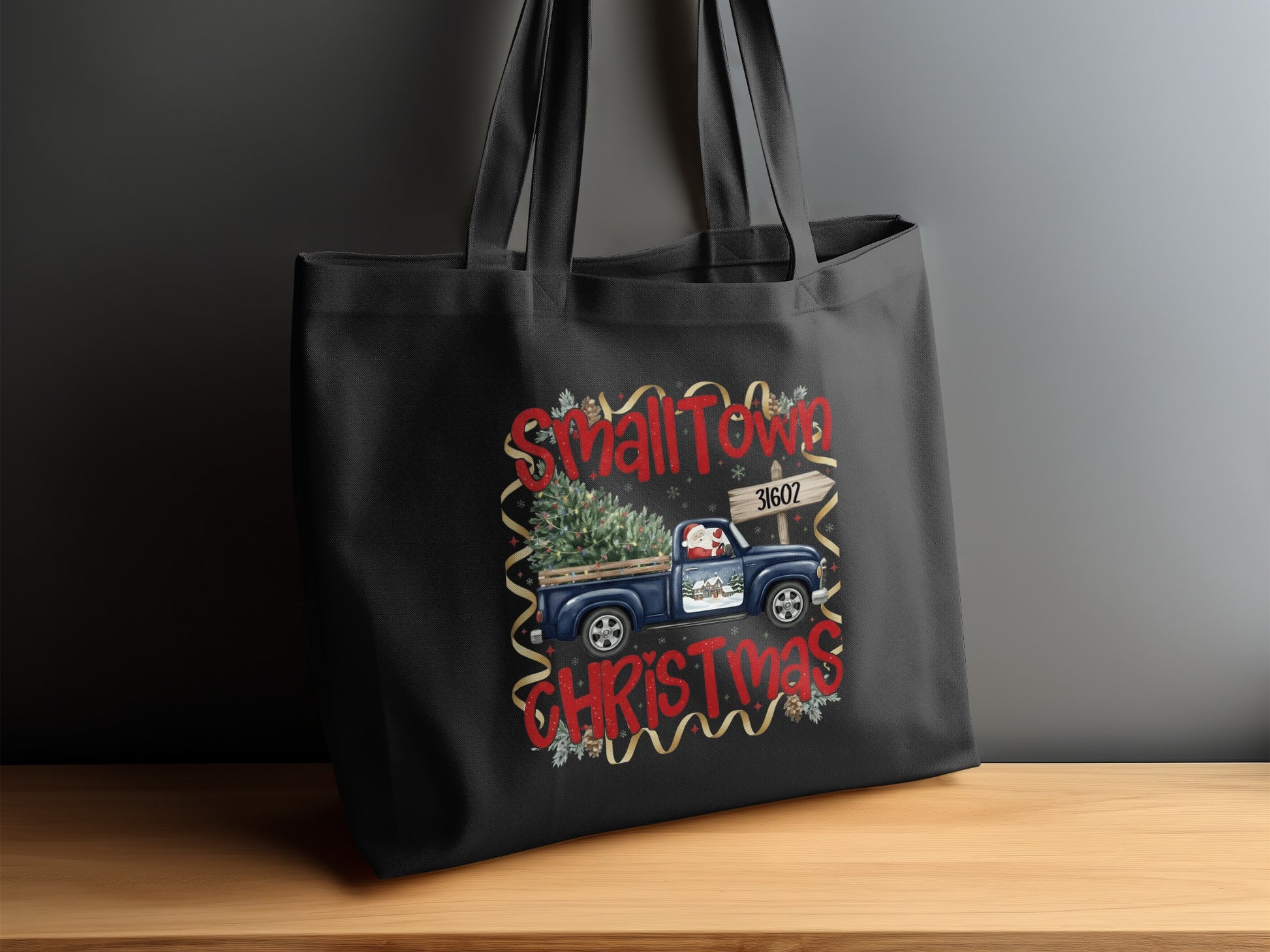 Black tote bag with "Small Town Christmas" design and blue truck.