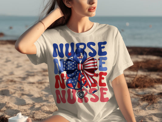 White t-shirt with patriotic ribbon and stethoscope, spelling out "NURSE".