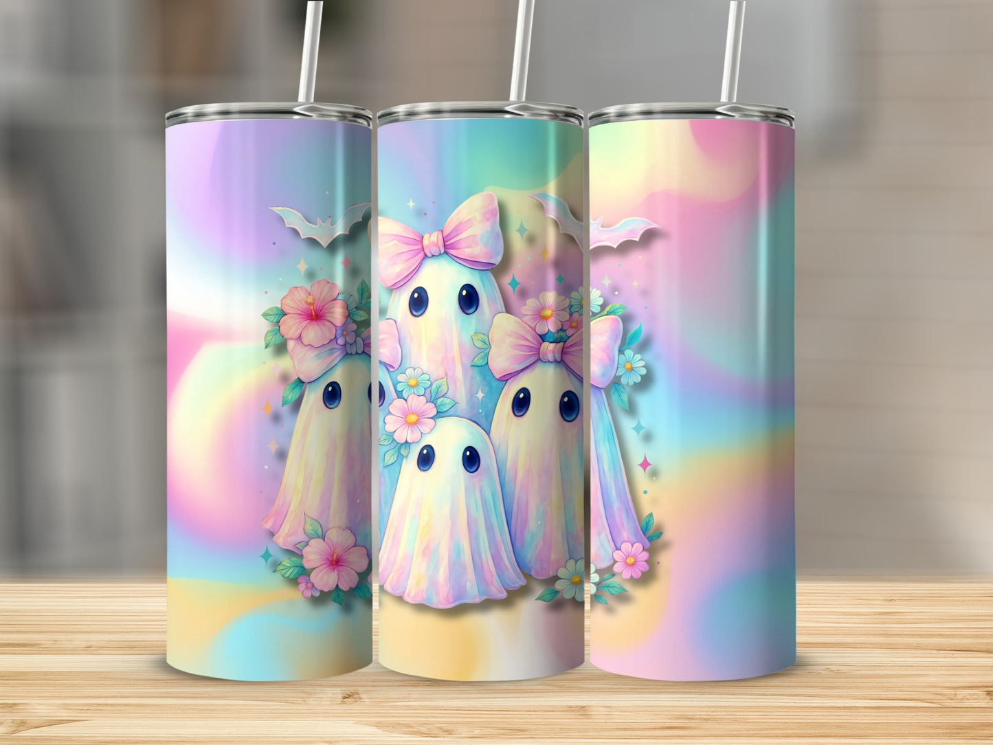 Three tumblers with pastel ghosts, pink bows, flowers, and bats.