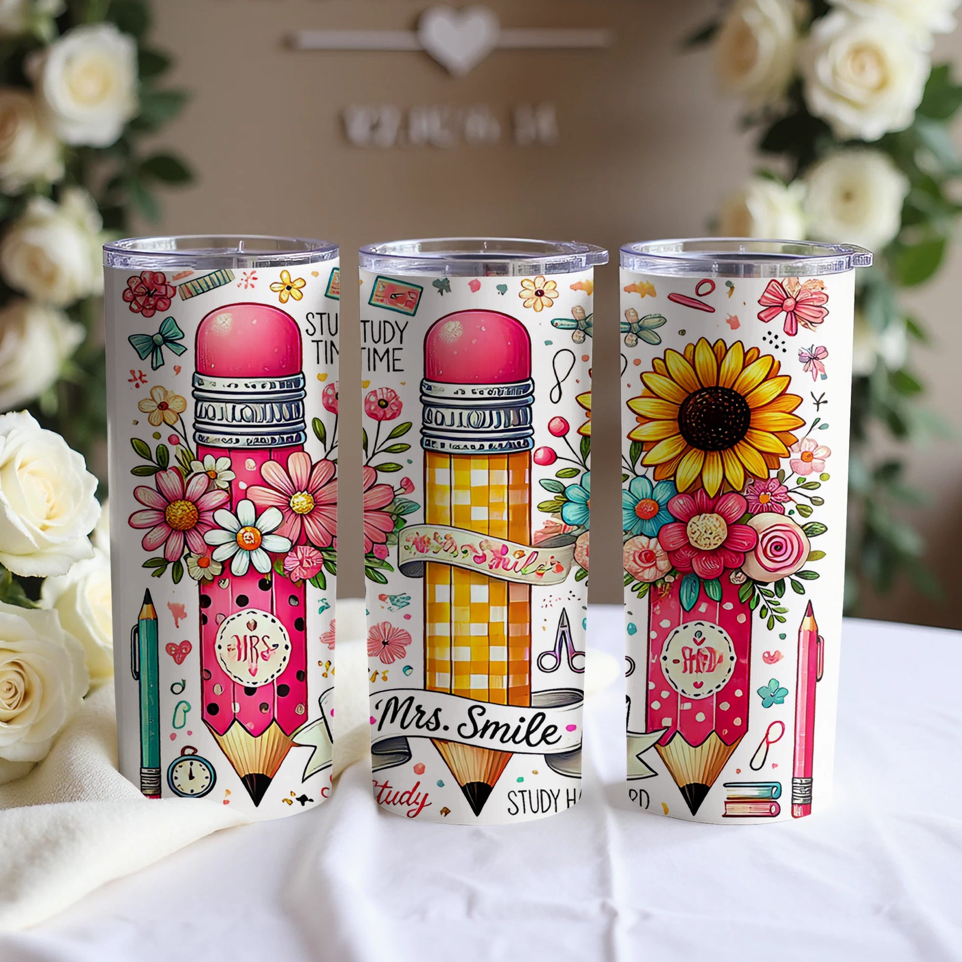 Three pink tumblers with floral and pencil designs, two read "Study Time", one reads "Mrs. Smile".