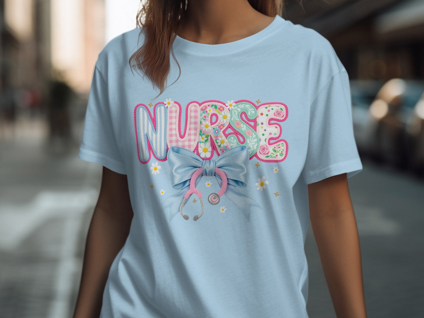 Light blue t-shirt with pastel "NURSE" text and stethoscope graphic.