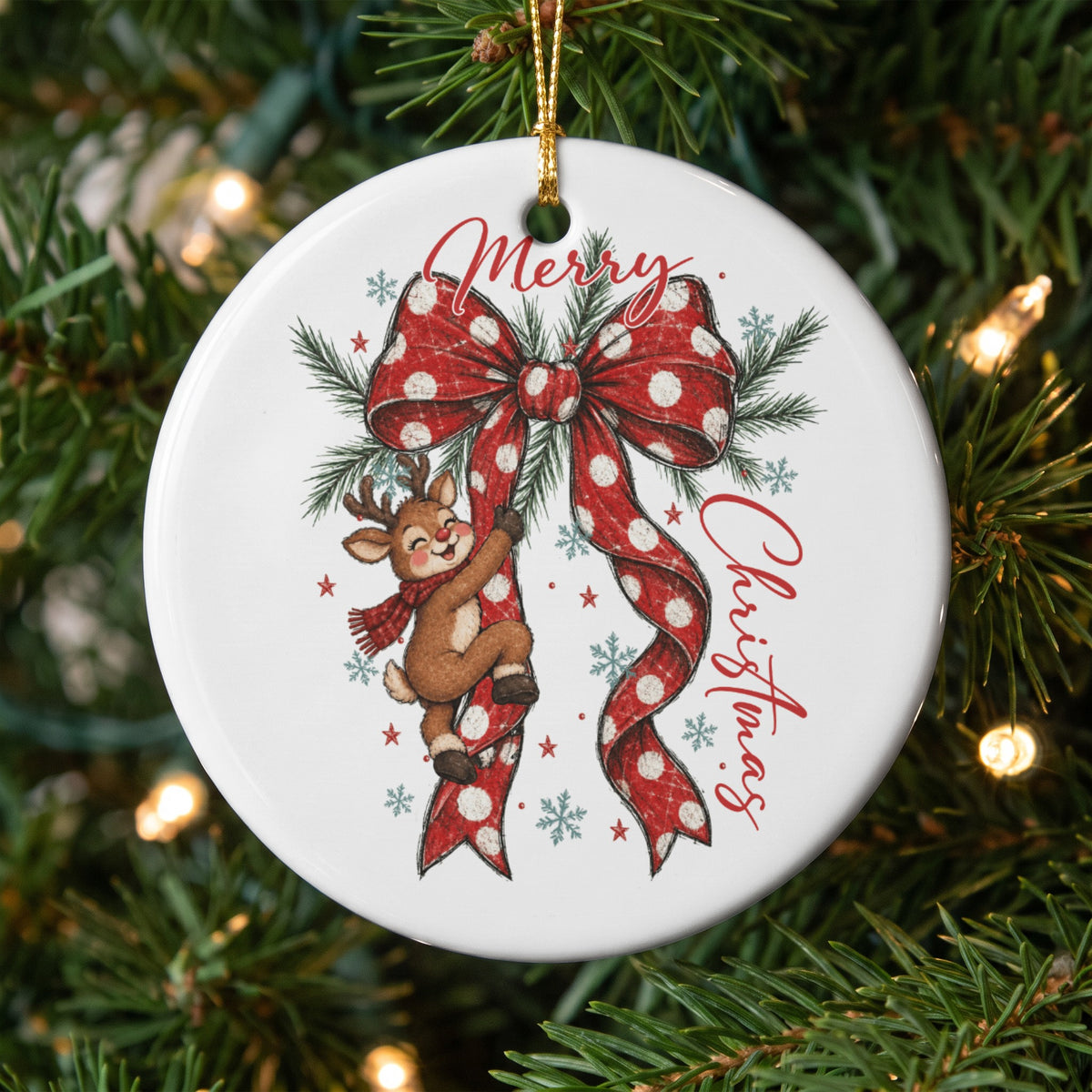 Round Christmas ornament with a reindeer climbing a red polka dot bow, "Merry Christmas" text.