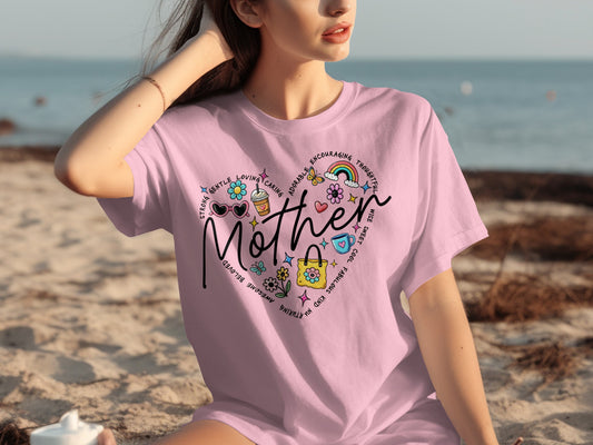 Pink t-shirt with "Mother" in a heart shape surrounded by positive words and icons.