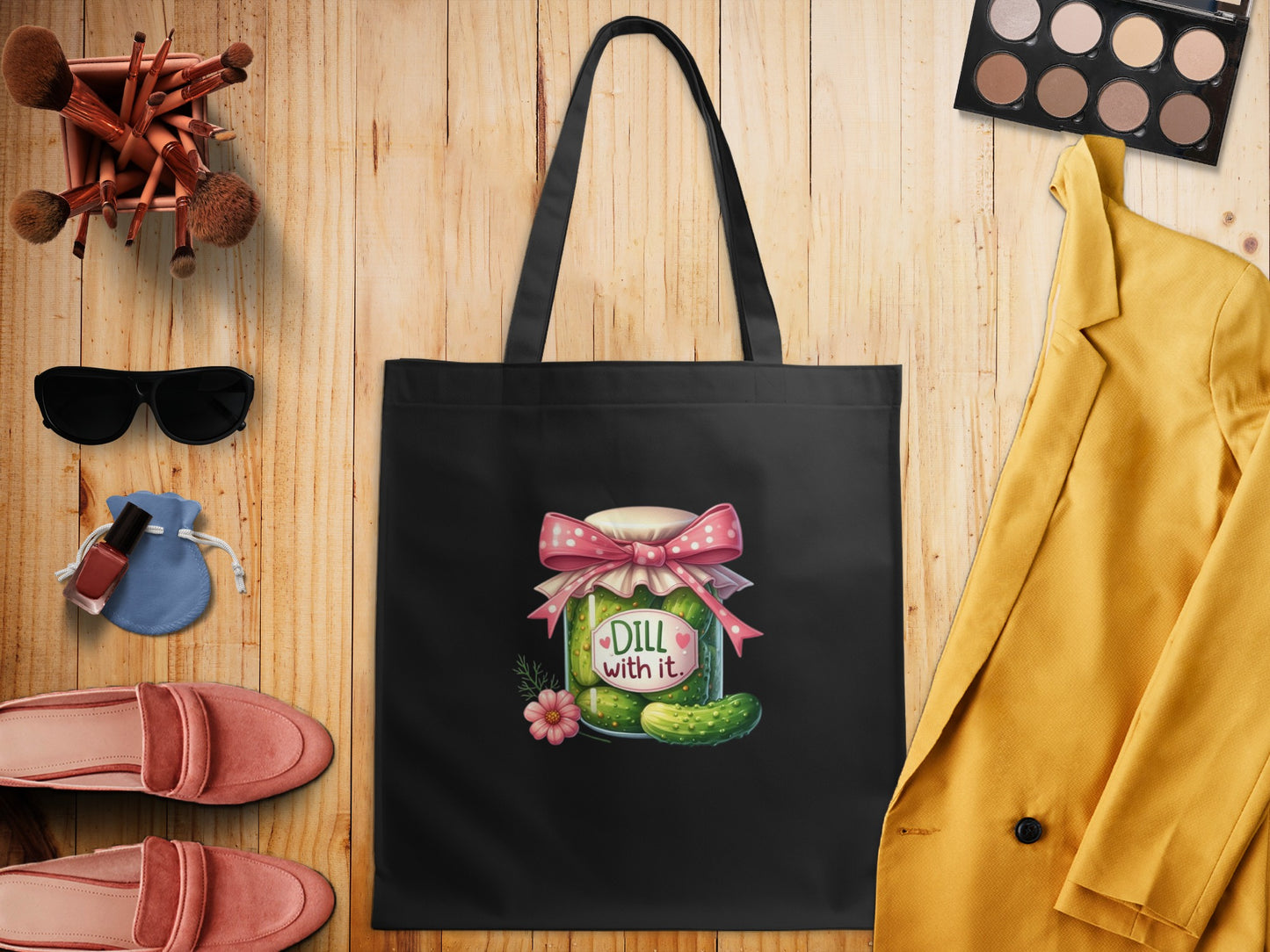 Black tote bag with a cartoon pickle jar and the text "Dill with it."