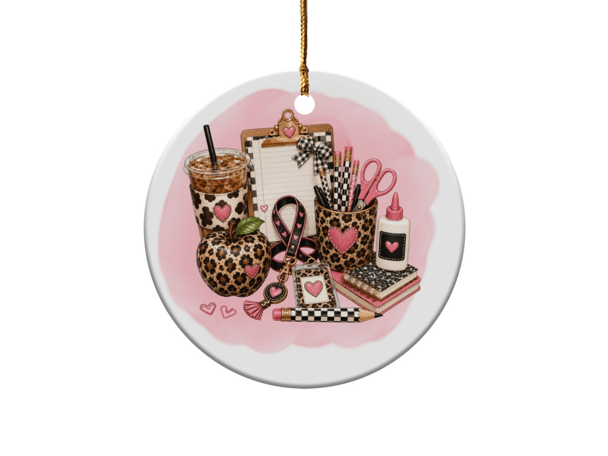 Leopard print apple, coffee, clipboard, and school supplies on a pink watercolor background.
