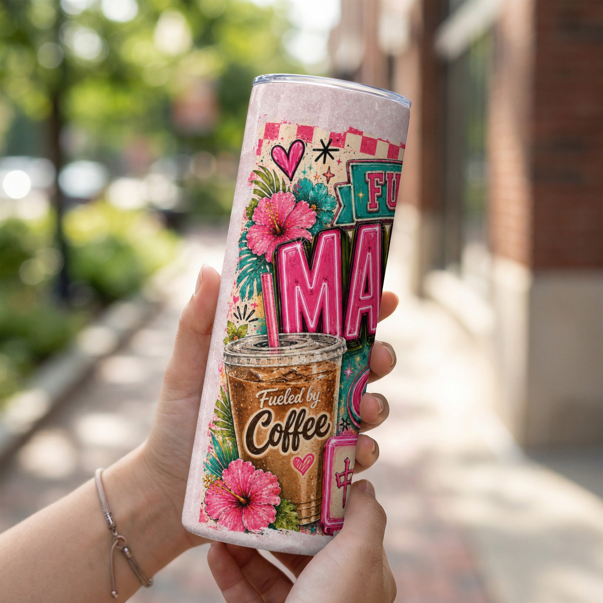 Tumbler with "Fueled by Coffee" and tropical hibiscus flowers design.