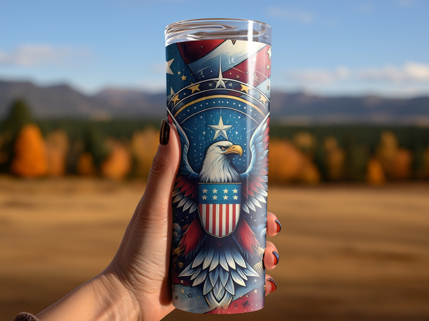 Tumbler with patriotic eagle and stars design held by a hand.