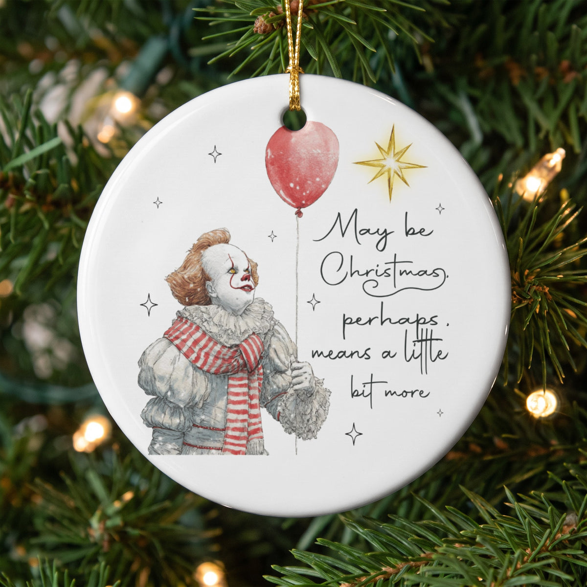 Ornament with Pennywise holding a balloon and text "May be Christmas, perhaps, means a little bit more."