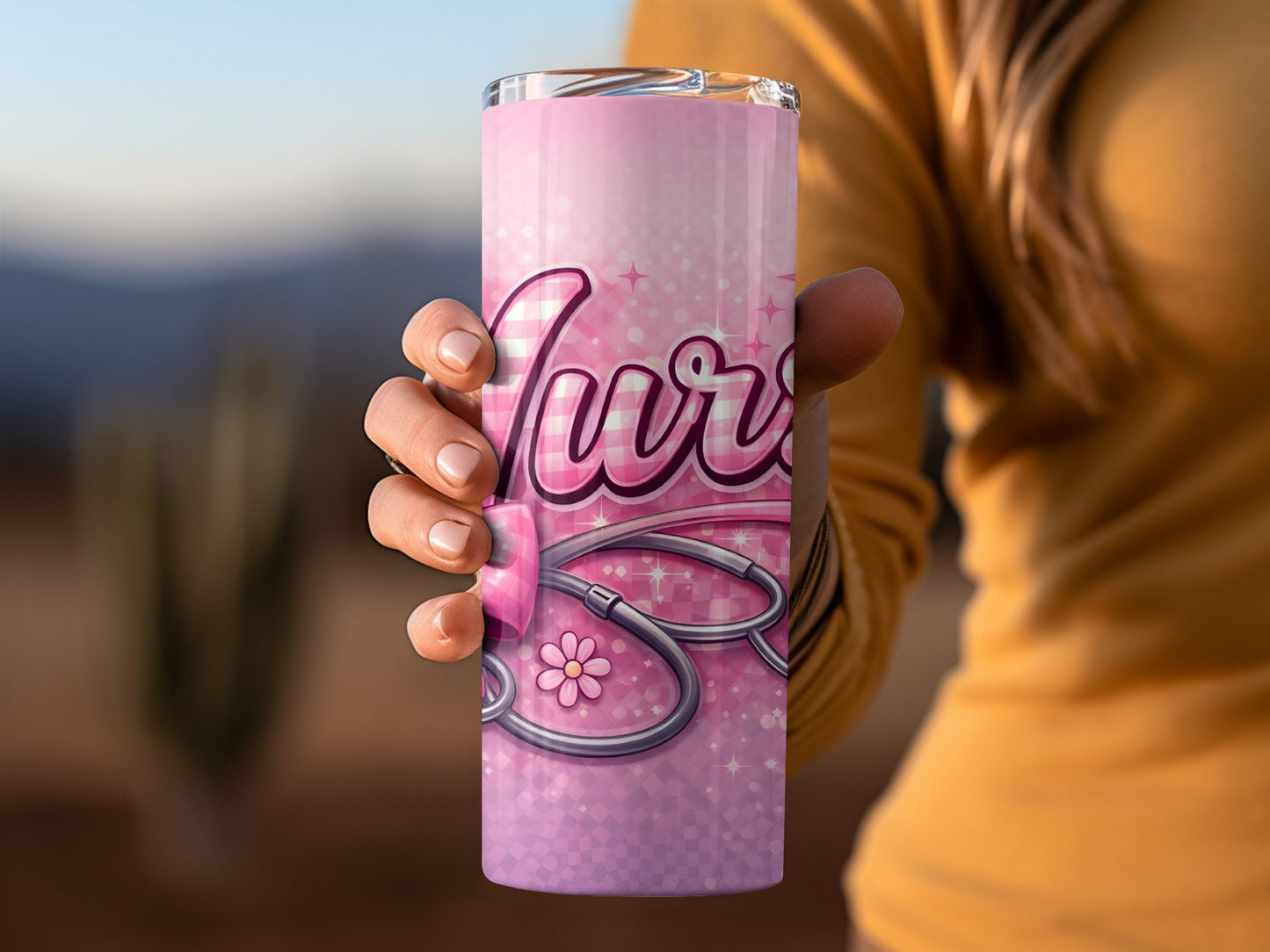 Pink nurse tumbler with stethoscope and flower design.