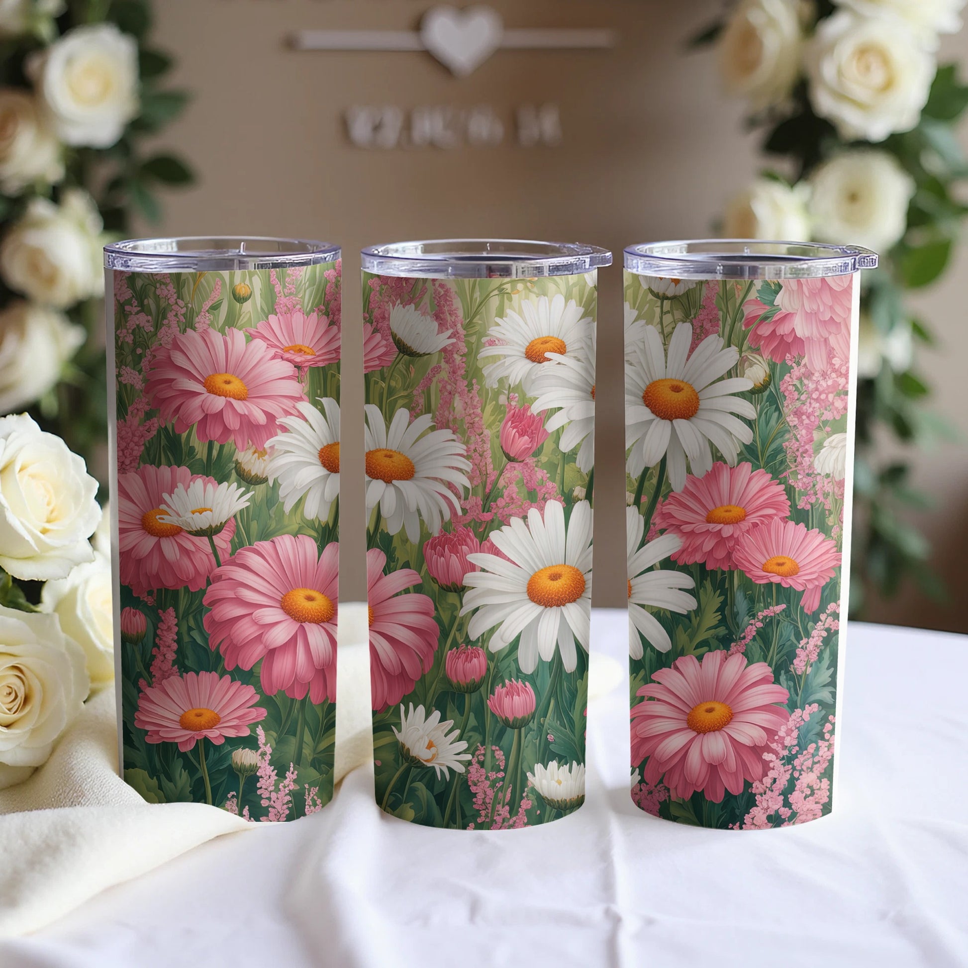 Three tumblers with a floral daisy and pink bloom design.