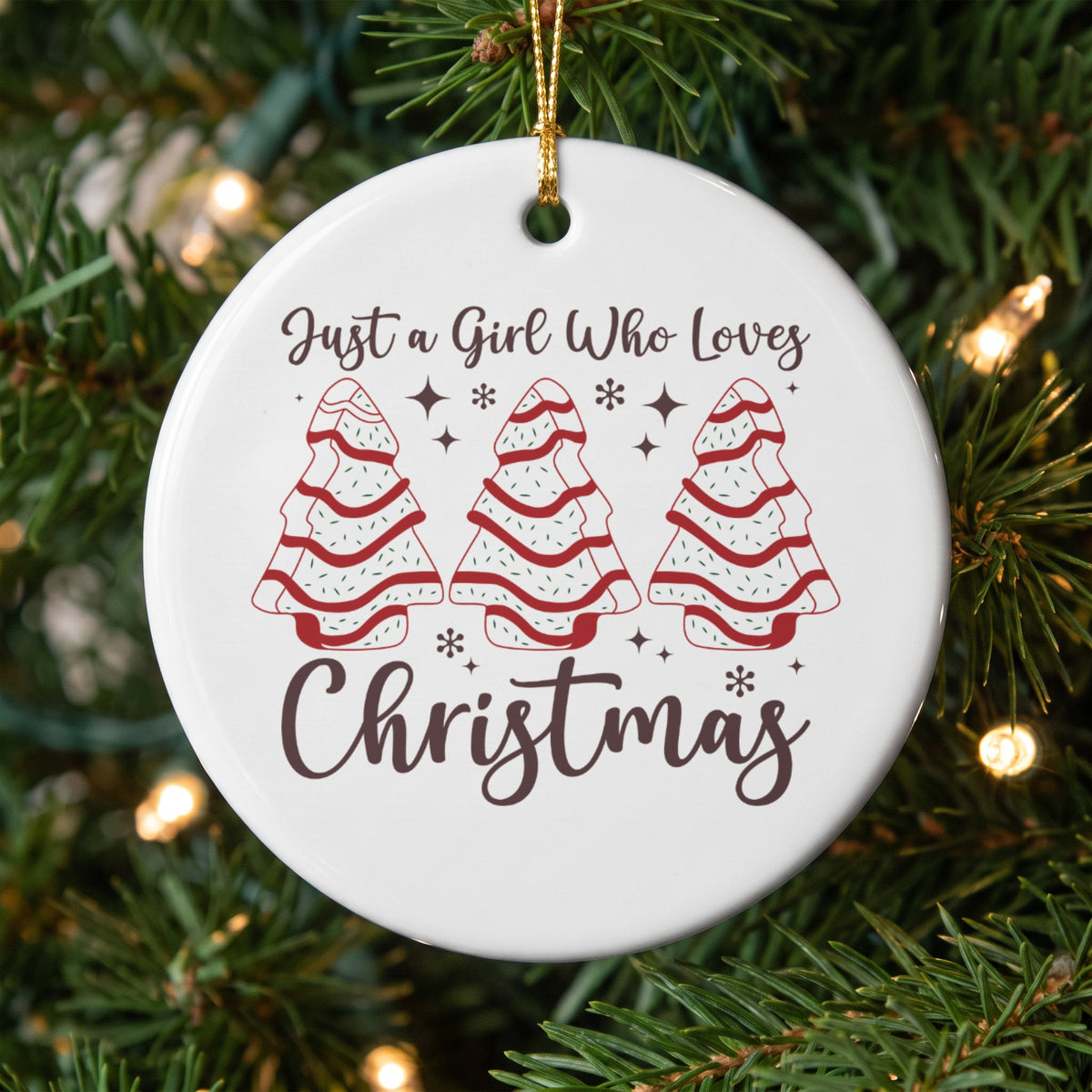 Round ornament with "Just a Girl Who Loves Christmas" and tree designs.