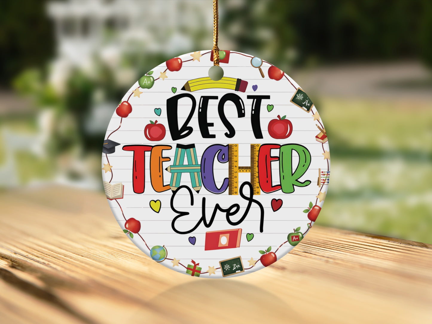 Round ornament with "Best Teacher Ever" text and school-themed illustrations.