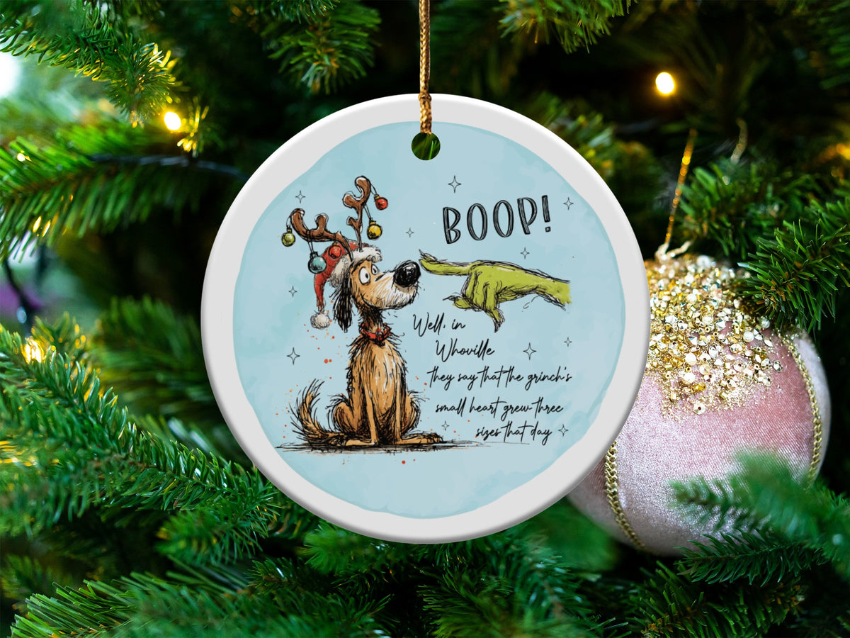Round ornament with Max the dog and the Grinch's finger saying "BOOP!"