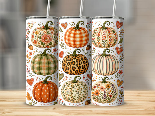 Three tumblers with various pumpkin designs and fall accents.