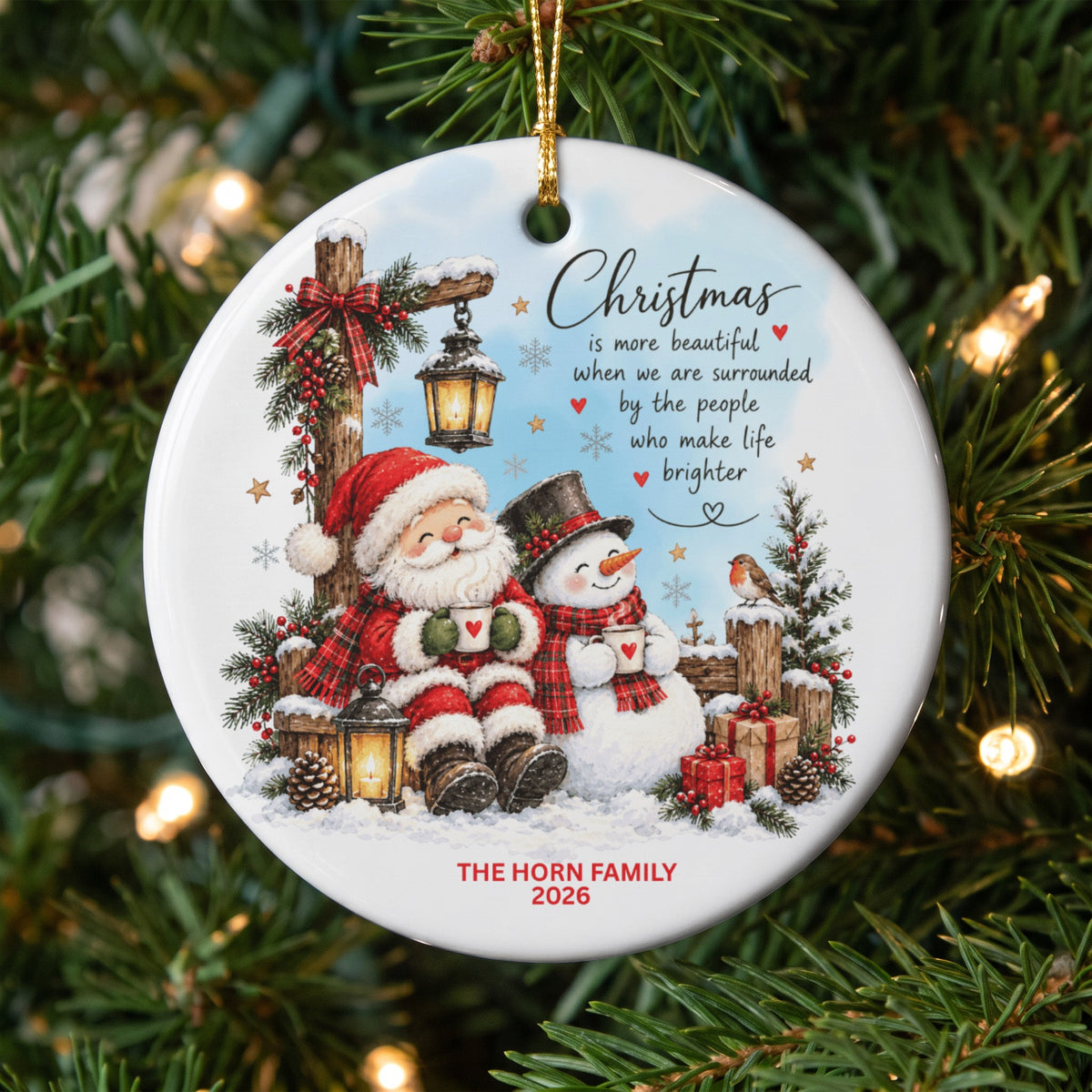 Round ceramic Christmas ornament featuring Santa and a snowman holding mugs, with personalized family text.