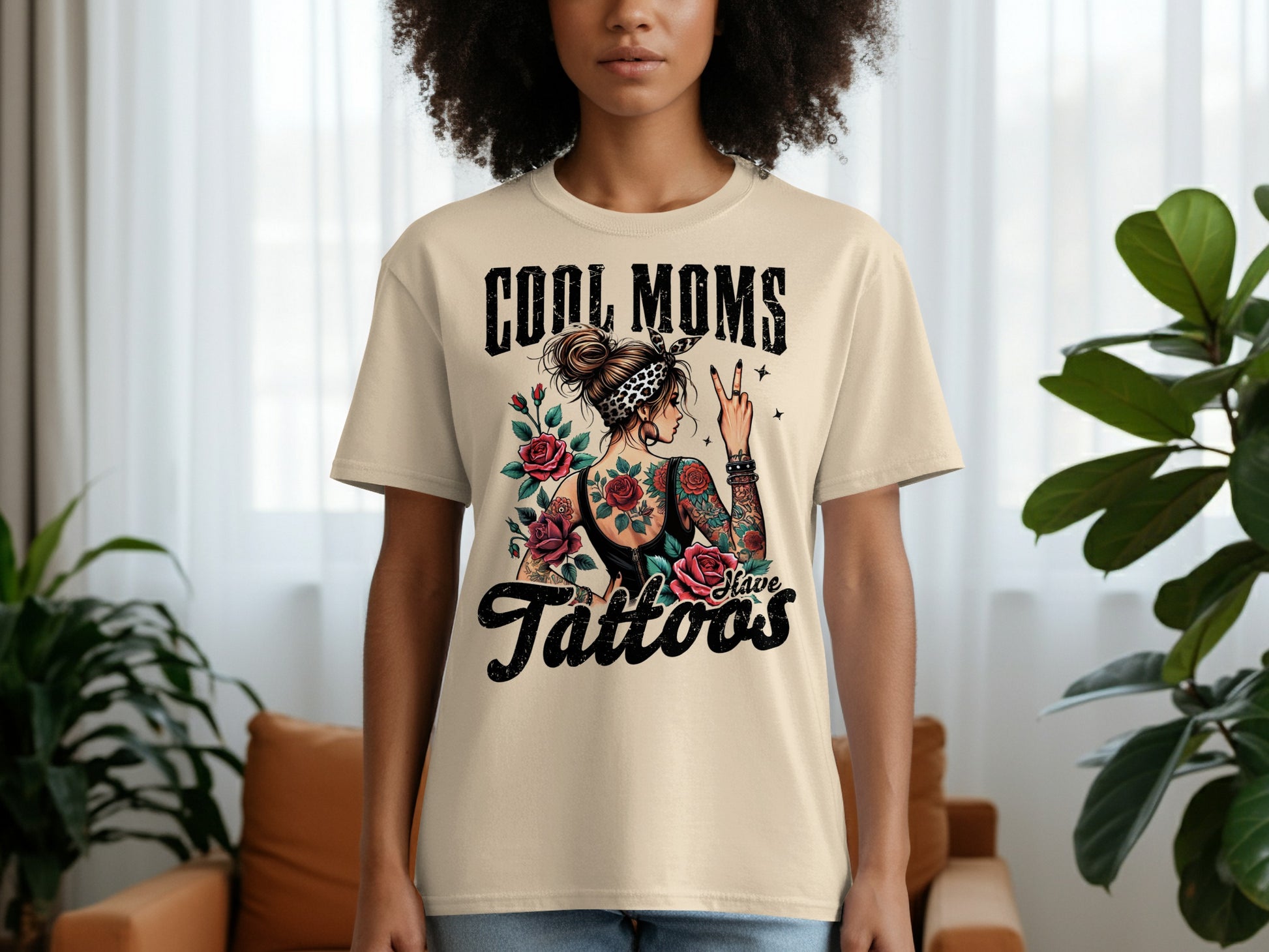 Cream t-shirt with "Cool Moms Have Tattoos" text and rose tattoo graphic.