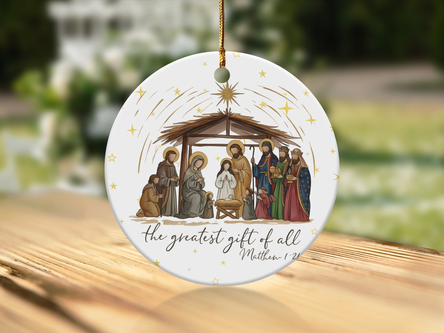 Nativity scene ornament with text "the greatest gift of all Matthew 1:21".