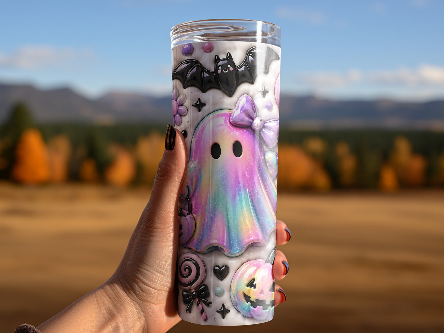 Tumbler with iridescent ghost, bat, pumpkin, and lollipop Halloween design.