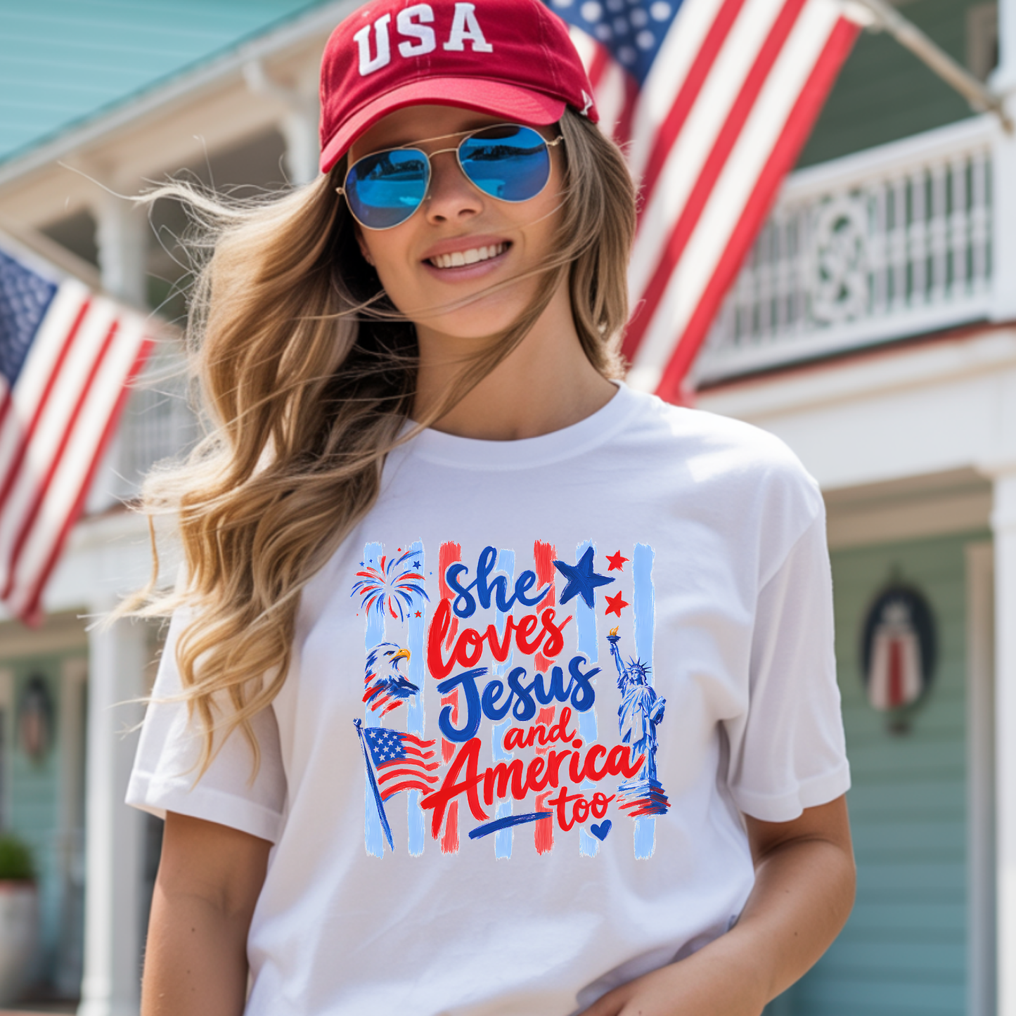Woman wearing a white t-shirt with patriotic design, red cap, and sunglasses in front of American flags.