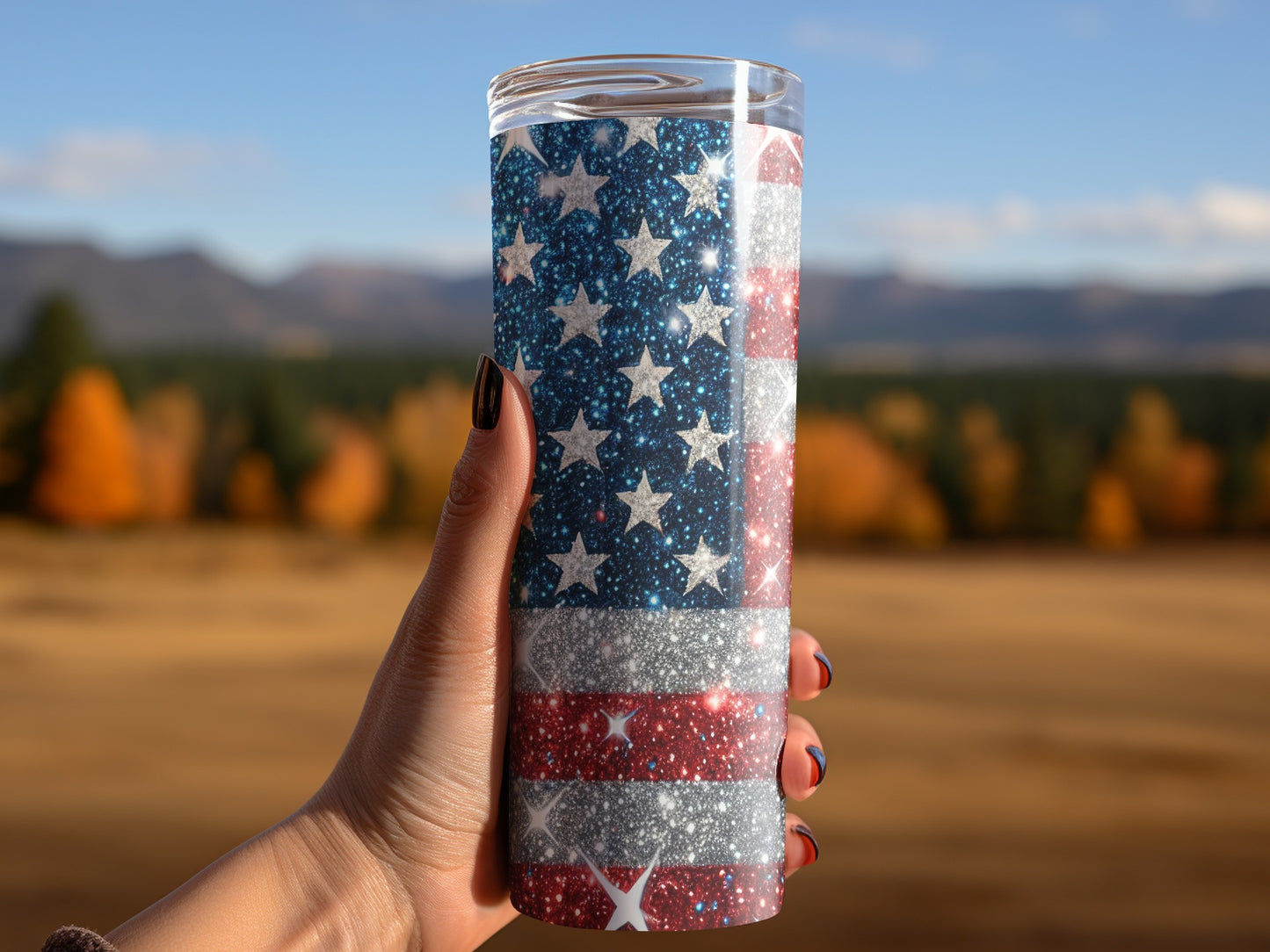 Tumbler with glittery American flag design held by a hand.
